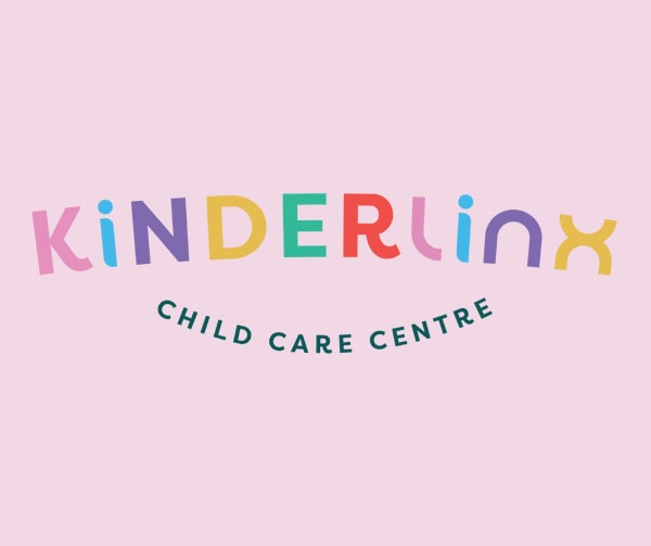 Logo for Kinderlinx Child Care Centre with KINDERLINX in colorful, playful letters and CHILD CARE CENTRE below in a curved, dark green font, on a light pink background.